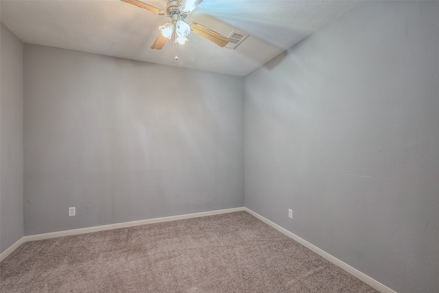 unfurnished room featuring ceiling fan and carpet flooring