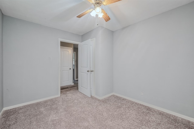 unfurnished room with light colored carpet and ceiling fan