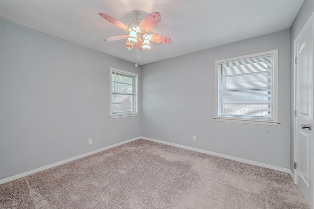 empty room with light colored carpet and ceiling fan