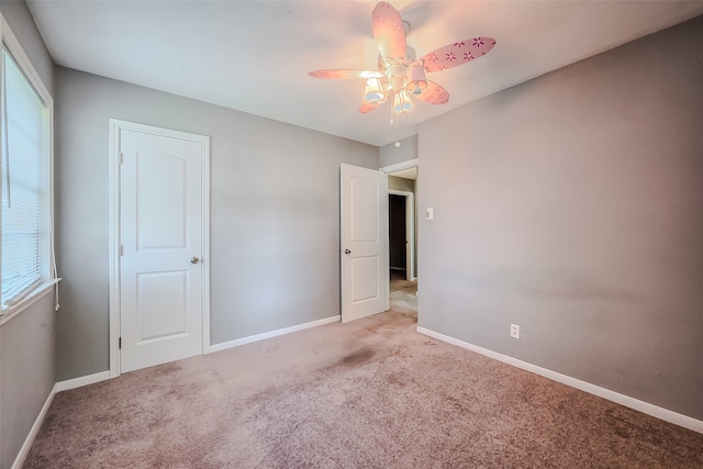 unfurnished bedroom with ceiling fan and light carpet