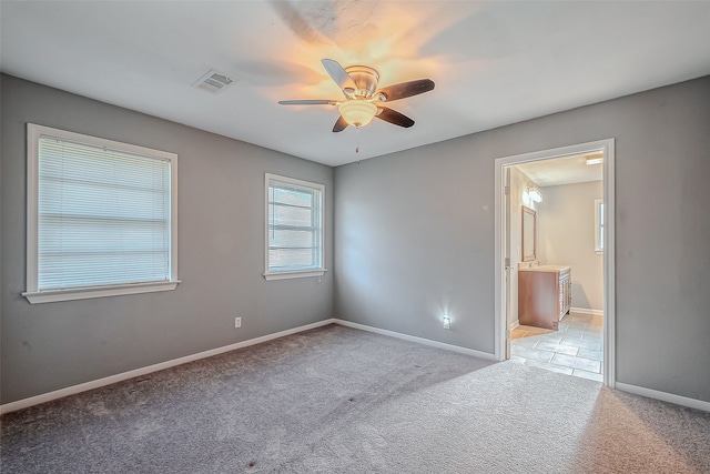 carpeted empty room featuring ceiling fan