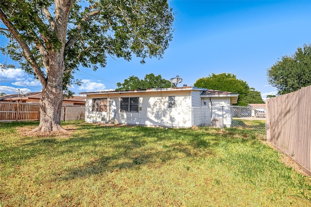 rear view of house with a lawn