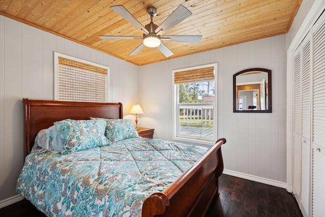 bedroom featuring wooden ceiling, dark wood-type flooring, a closet, and ceiling fan