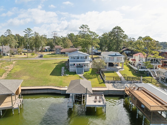 dock area with a water view and a yard