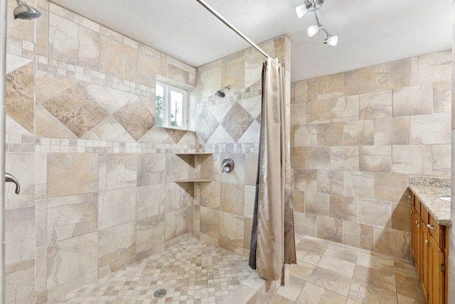 bathroom with vanity and curtained shower