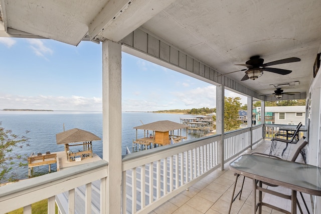 exterior space with a water view and ceiling fan