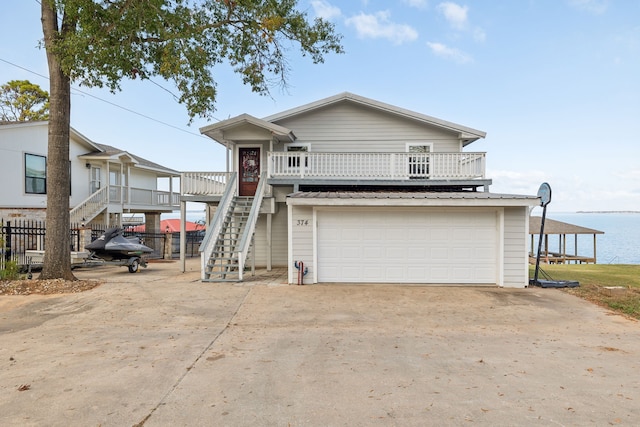 view of front of house with a deck with water view and a garage