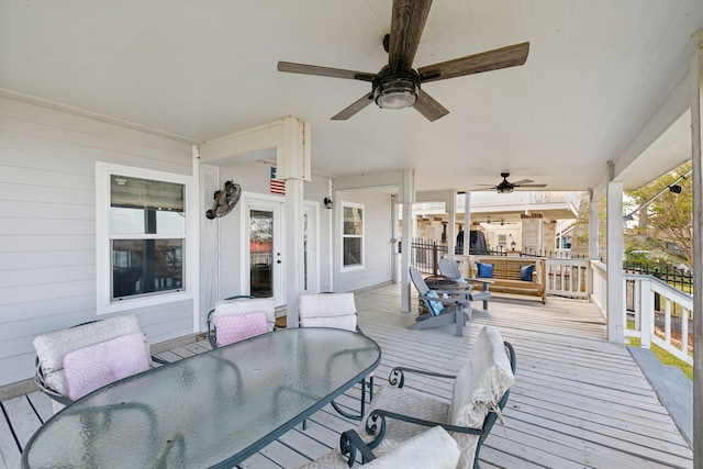 wooden terrace featuring ceiling fan