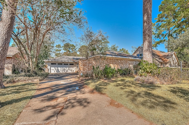 view of front of property with a garage and a front lawn