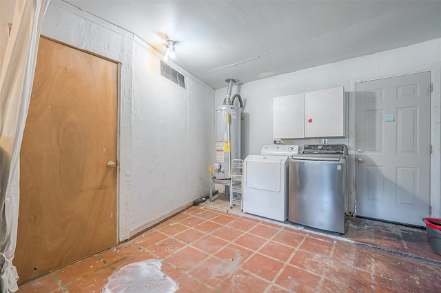 laundry room featuring water heater, cabinets, and independent washer and dryer