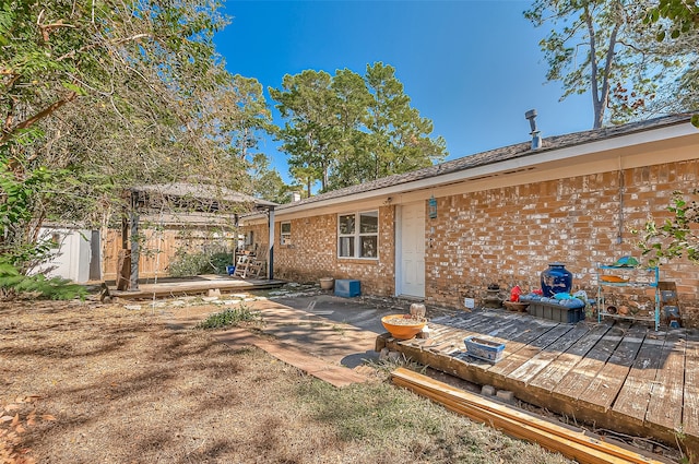 back of house featuring a wooden deck