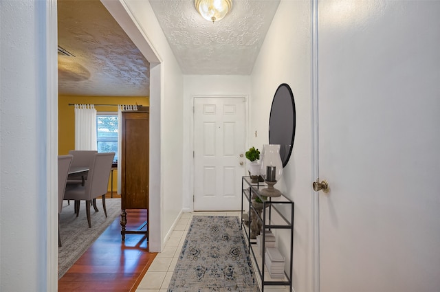 foyer entrance featuring hardwood / wood-style floors and a textured ceiling