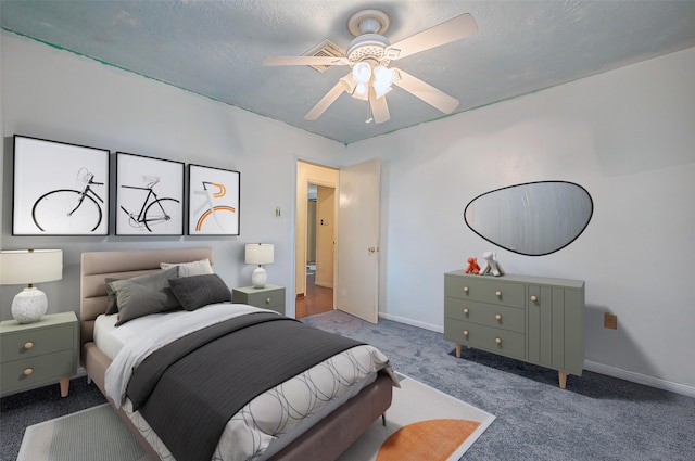 carpeted bedroom featuring a textured ceiling and ceiling fan