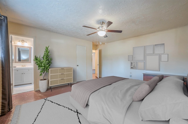 bedroom featuring wood-type flooring, a textured ceiling, ensuite bath, and ceiling fan