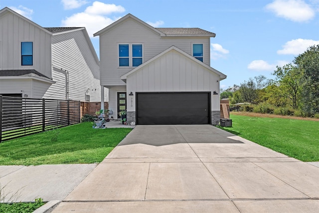 view of front of house with a front yard and a garage