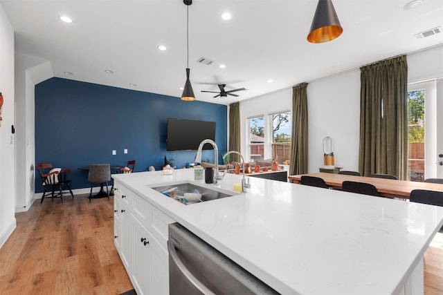 kitchen with dishwasher, sink, an island with sink, and decorative light fixtures