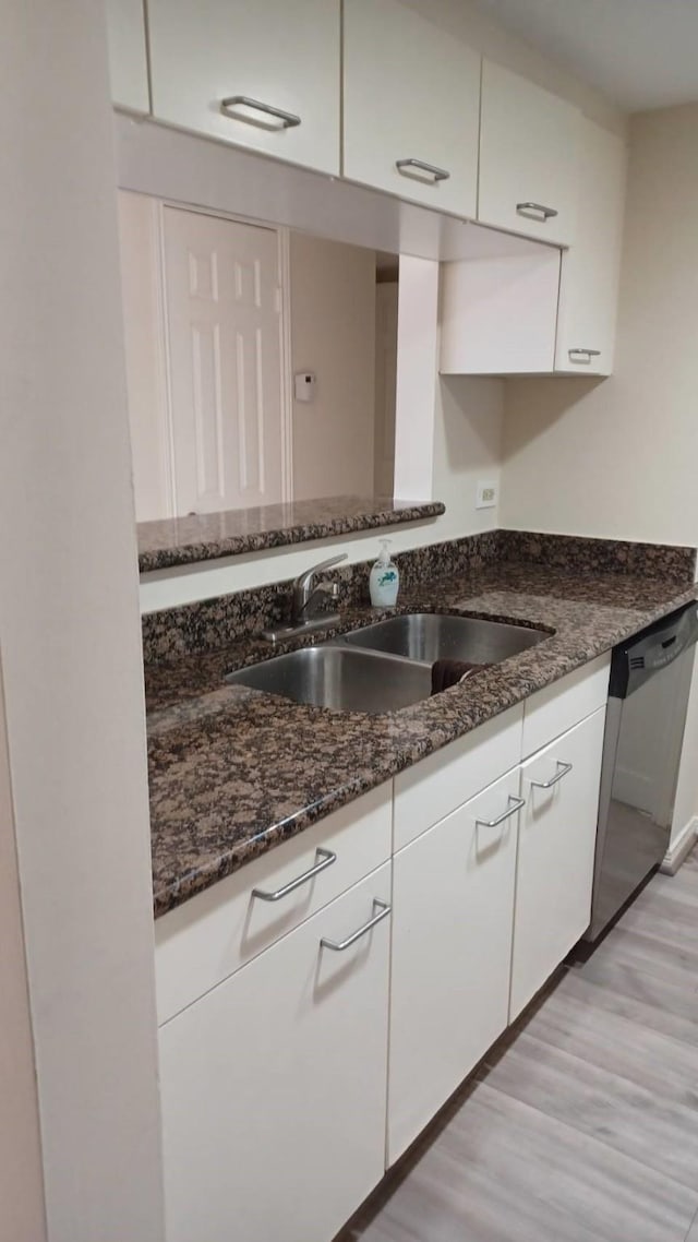 3525 Sage Rd Unit 1202, Houston, TX 77056 - kitchen featuring stainless steel dishwasher, white cabinetry, dark stone countertops, and light wood finished floors