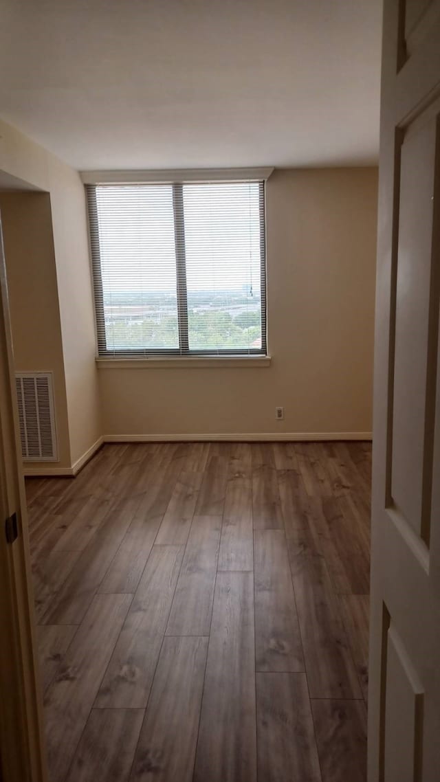 empty room with hardwood / wood-style floors