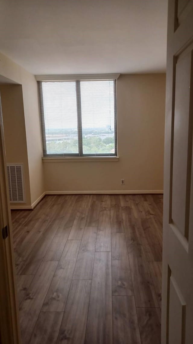 3525 Sage Rd Unit 1202, Houston, TX 77056 - empty room featuring healthy amount of natural light and wood finished floors