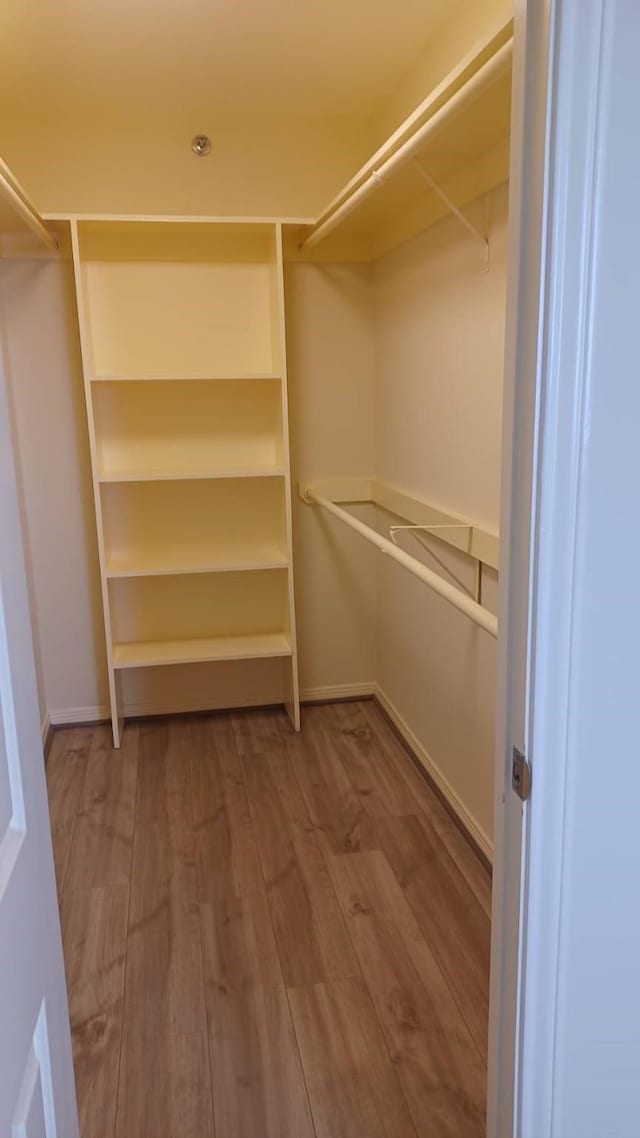 3525 Sage Rd Unit 1202, Houston, TX 77056 - walk in closet featuring wood finished floors