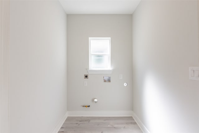 laundry room featuring hookup for a gas dryer, hookup for an electric dryer, washer hookup, and light hardwood / wood-style floors