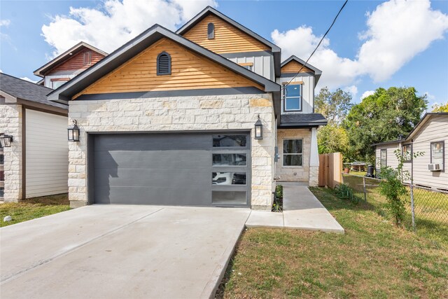 view of front of home with a garage and a front lawn