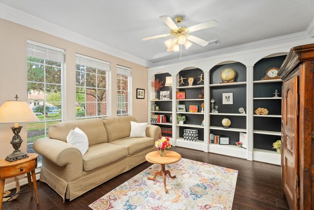 living area with crown molding, ceiling fan, and dark hardwood / wood-style flooring