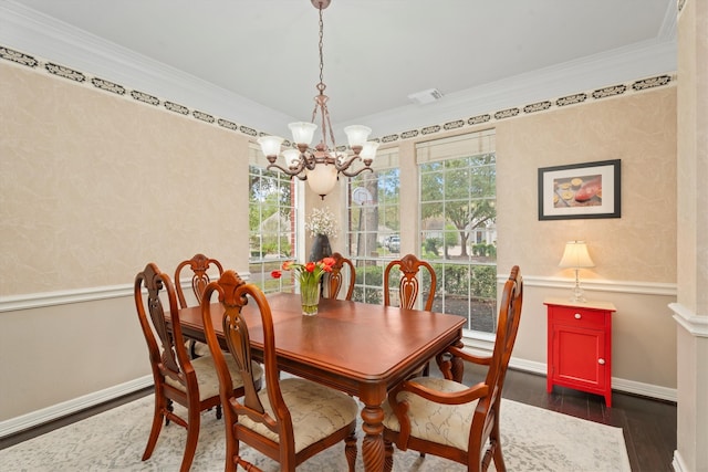 dining area with crown molding, dark hardwood / wood-style floors, and a chandelier