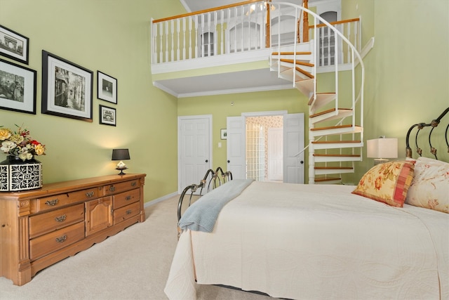 bedroom featuring crown molding, light carpet, and a high ceiling