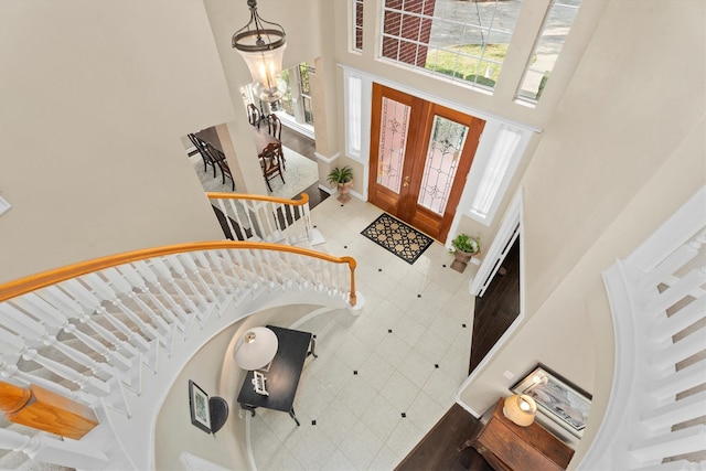 foyer entrance with a towering ceiling and an inviting chandelier