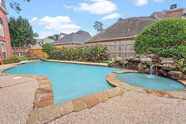 view of pool with an in ground hot tub