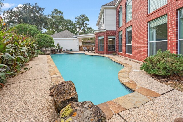 view of swimming pool with a patio area