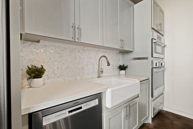 kitchen with dishwasher, sink, and backsplash