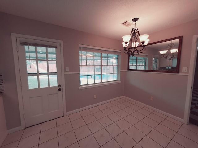 unfurnished dining area featuring a notable chandelier and light tile patterned floors