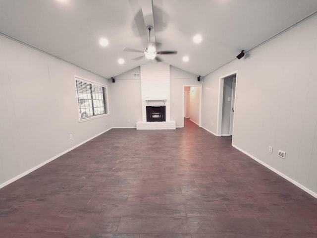 unfurnished living room with lofted ceiling, a brick fireplace, and ceiling fan