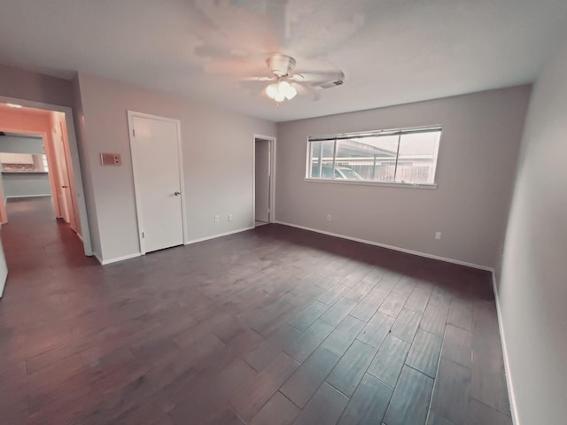 unfurnished bedroom with dark wood-type flooring and ceiling fan