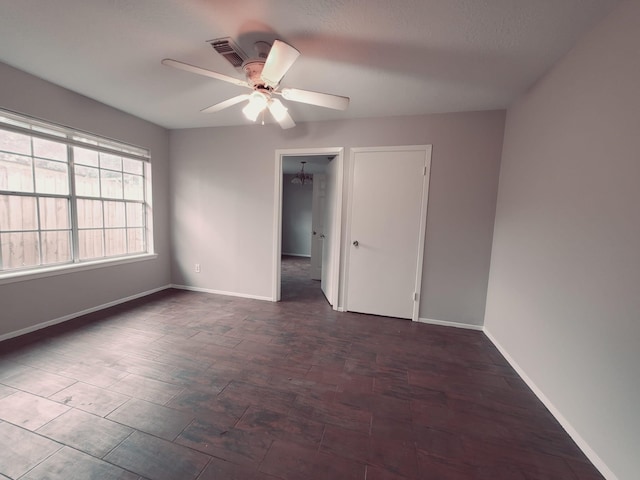 spare room featuring a textured ceiling and ceiling fan