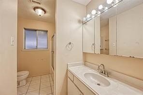 bathroom featuring vanity, toilet, and tile patterned floors