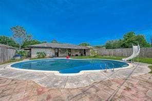 view of pool with a patio and a water slide