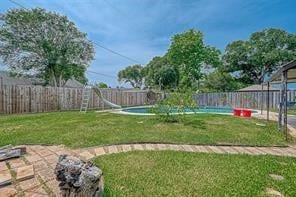 view of yard with a fenced in pool and a patio area