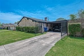 view of side of home featuring a lawn and a carport