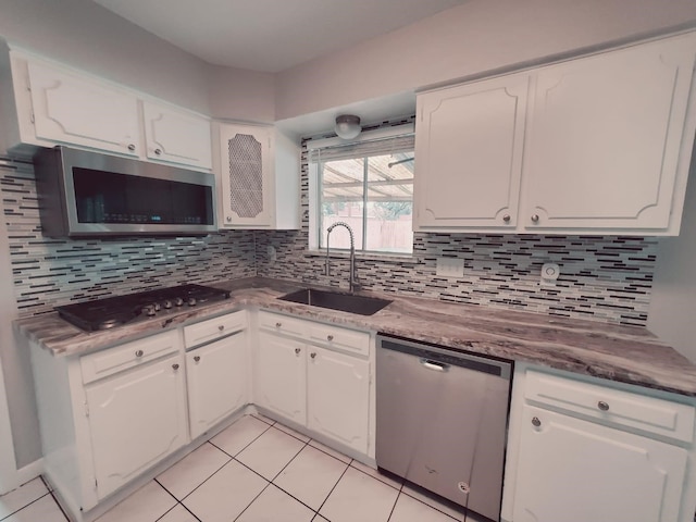 kitchen featuring sink, white cabinets, stainless steel appliances, and tasteful backsplash