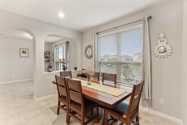 3522 Lake Lugano Cir, Katy, TX 77493 - dining area featuring arched walkways, light tile patterned floors, baseboards, and recessed lighting