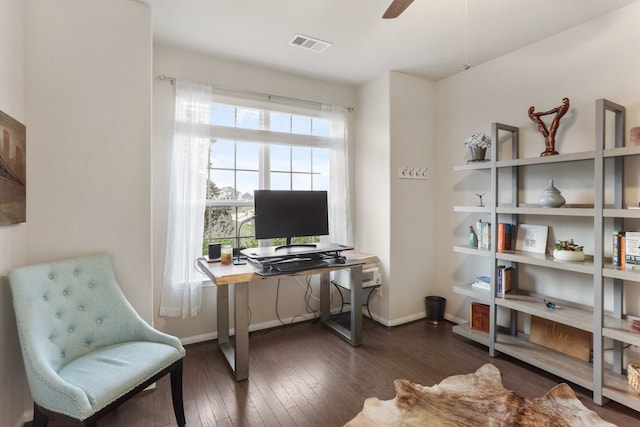 home office with dark hardwood / wood-style flooring and ceiling fan