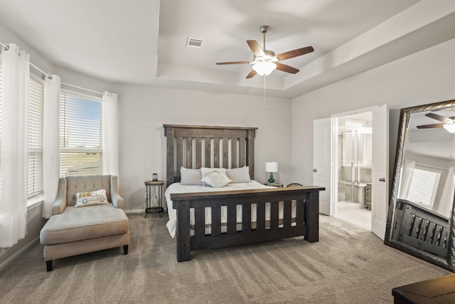 3522 Lake Lugano Cir, Katy, TX 77493 - carpeted bedroom featuring a raised ceiling, a ceiling fan, ensuite bathroom, and baseboards