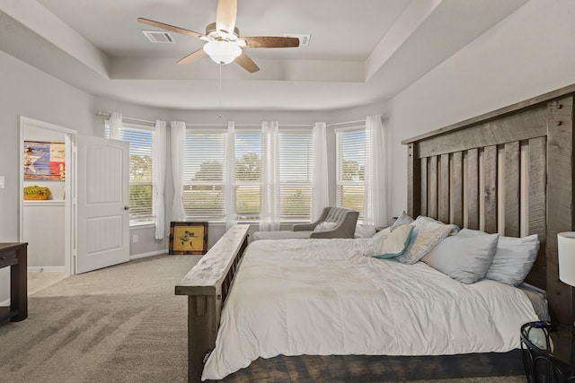 3522 Lake Lugano Cir, Katy, TX 77493 - carpeted bedroom featuring a raised ceiling, multiple windows, baseboards, and ceiling fan