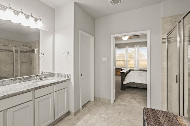 bathroom with ceiling fan, a shower with shower door, vanity, and tile patterned flooring