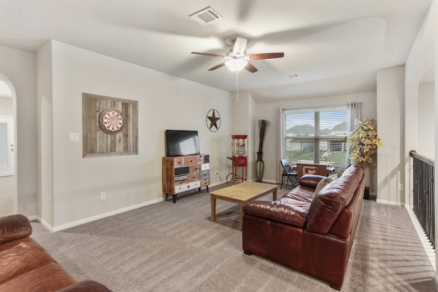 carpeted living room with ceiling fan