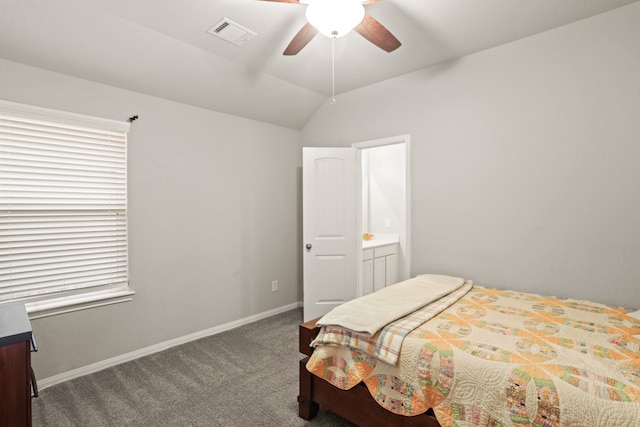 carpeted bedroom with connected bathroom, vaulted ceiling, and ceiling fan