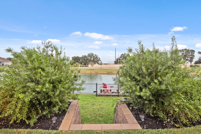 dock area with a yard and a water view